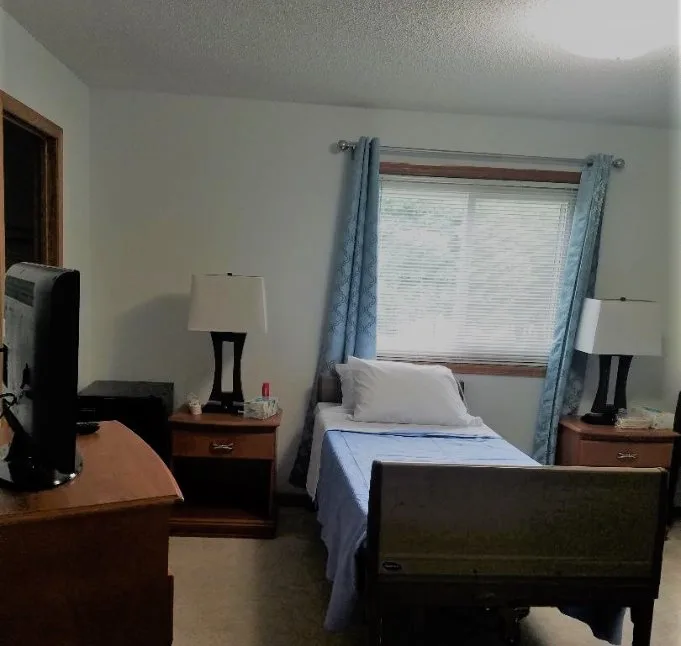 A resident bedroom with a window and fresh linens