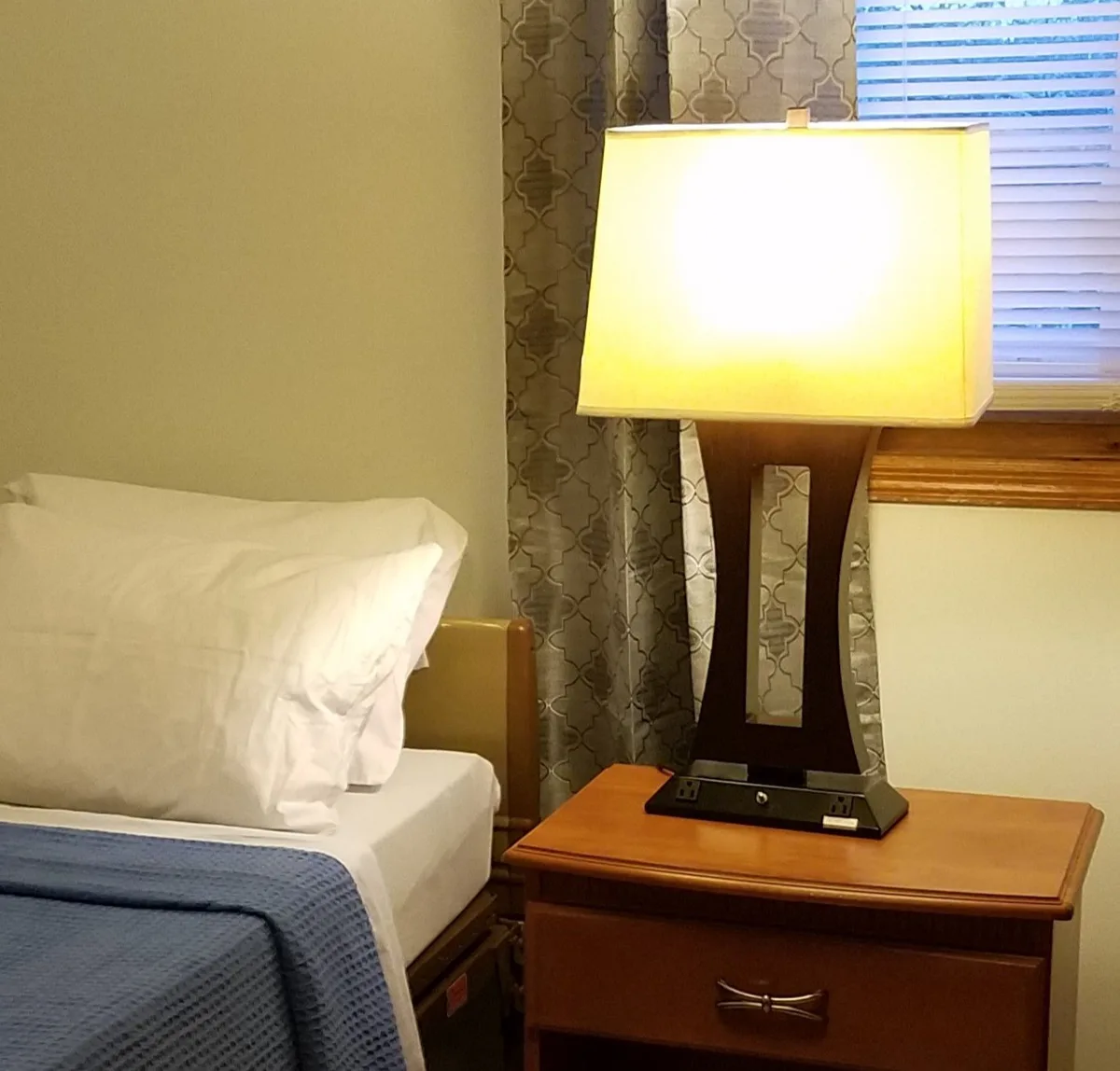 Warmly lit resident bedroom at Woodbridge House